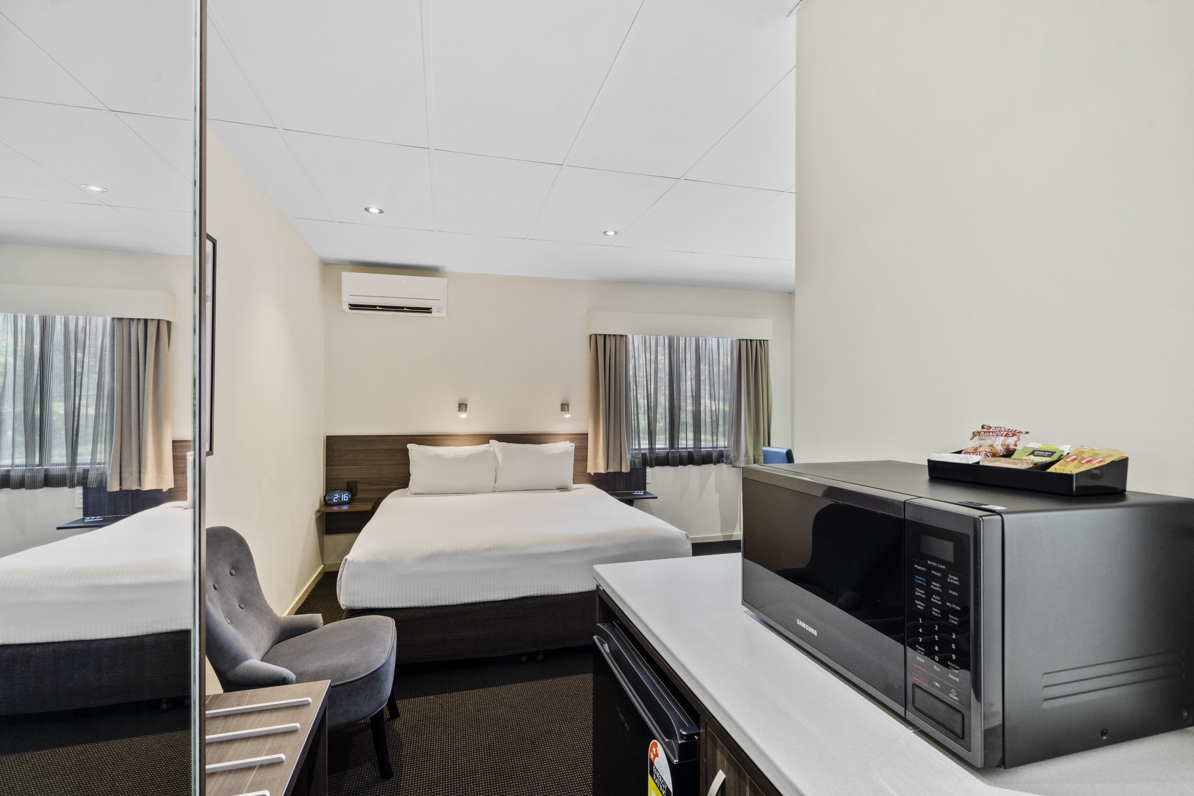 A self-contained studio room with a kitchenette and dining setting