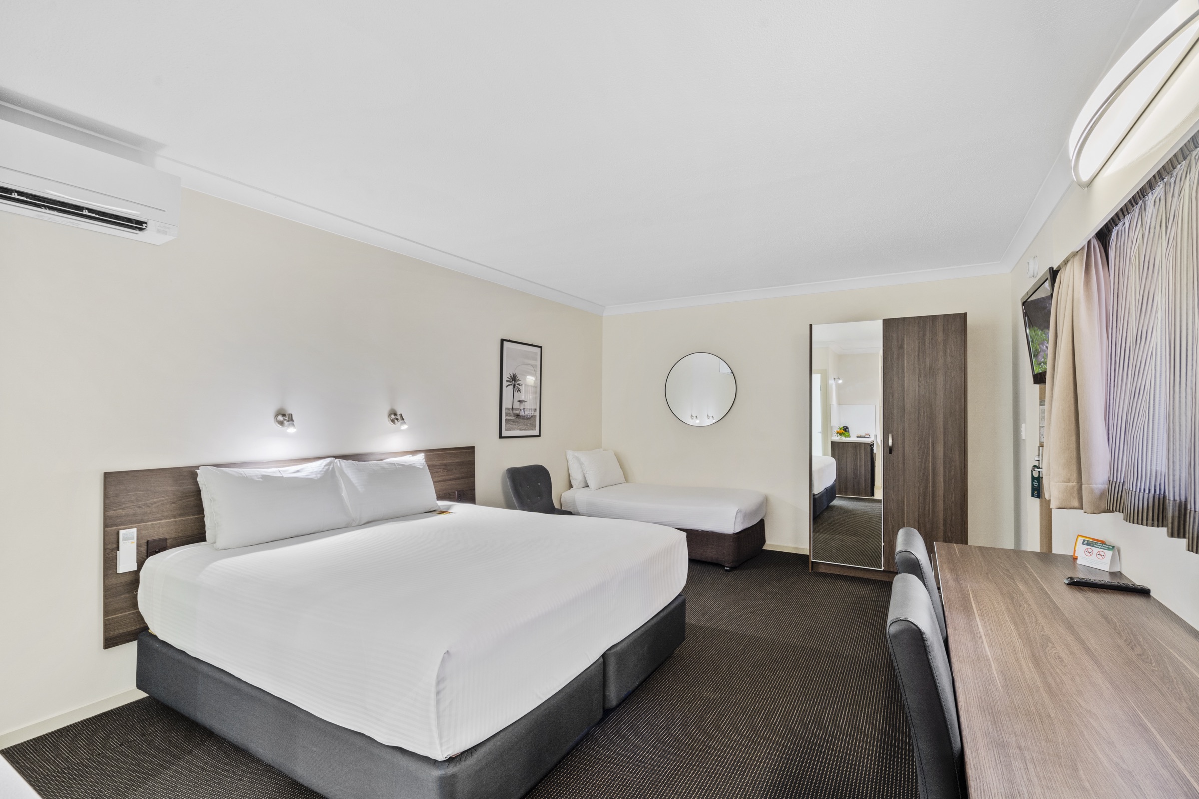 A spacious villa room with a king bed and sitting area
